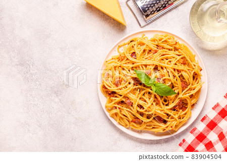 Homemade  pasta with pancetta, egg, hard parmesan cheese and cream sauce 83904504
