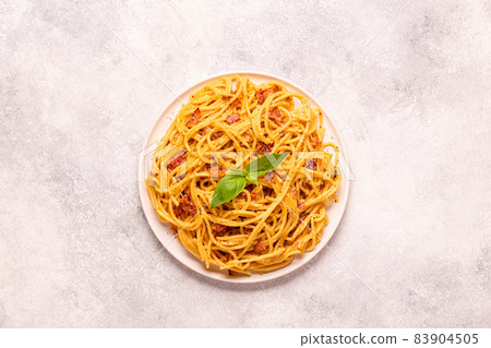 Homemade pasta with pancetta, egg, hard parmesan cheese and cream sauce 83904505