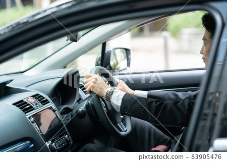 Car steering wheel businessman Car steering wheel businessman 83905476