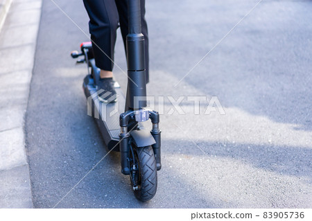 People riding electric kickboards and electric kick scooters 83905736