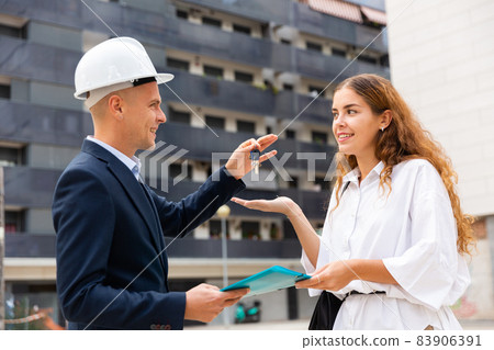 Builder giving keys to client after finishing signing contract Builder giving keys to client after finishing signing contract 83906391