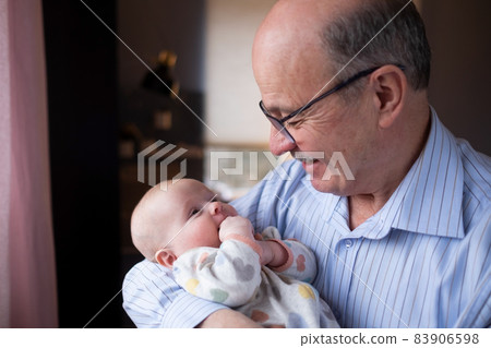 Grandfather holding a beautiful newborn baby girl 83906598