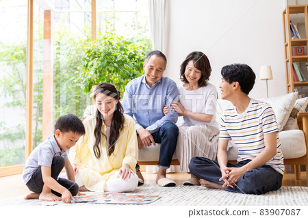 Three-generation family relaxing in the living room Three-generation family relaxing in the living room 83907087