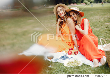 Elegant and stylish girls in a summer park Elegant and stylish girls in a summer park 83907286