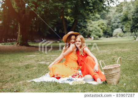 Elegant and stylish girls in a summer park Elegant and stylish girls in a summer park 83907287