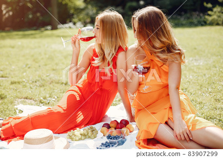 Elegant and stylish girls in a summer park Elegant and stylish girls in a summer park 83907299
