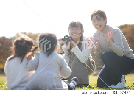 Mother taking pictures of children 83907425