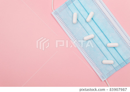 White Pills or Tablets on Medical Face Mask 83907987
