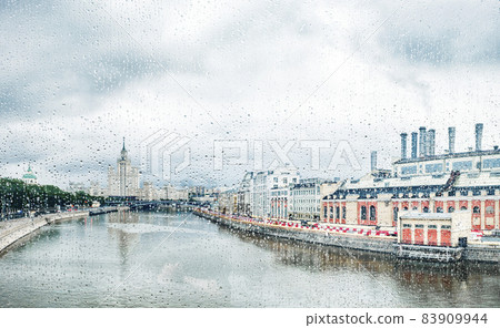 View through glass with raindrops of The Moskva River, Kotelnicheskaya Embankment Building in Moscow, Russia View through glass with raindrops of The Moskva River, Kotelnicheskaya Embankment Building in Moscow, Russia 83909944