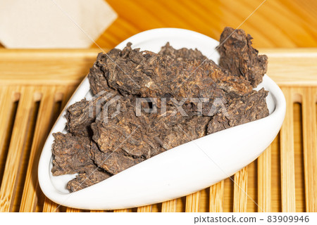 Chinese aged Puer Lao Cha Tou or Old Heads tea in a tea presentation vessel Chinese aged Puer Lao Cha Tou or Old Heads tea in a tea presentation vessel 83909946