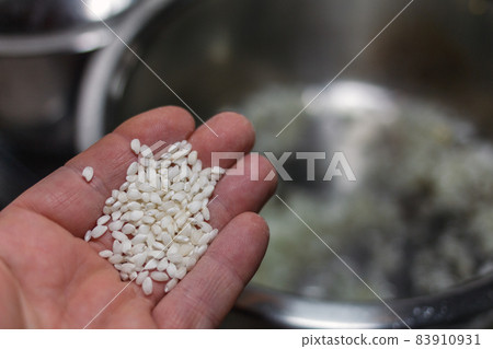 adding rice to a pot adding rice to a pot 83910931