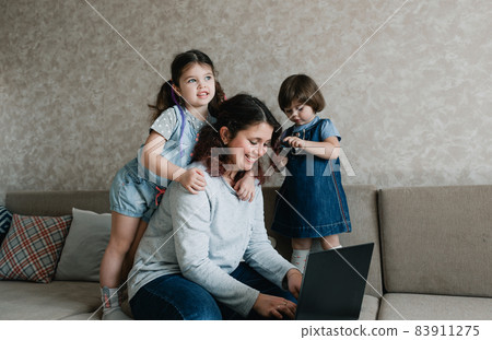 small children prevent their mother from working on the computer small children prevent their mother from working on the computer 83911275