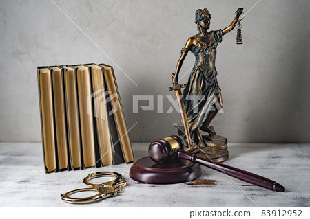 Lady Justice, Judge's gavel, books, handcuffs on an old wooden table Lady Justice, Judge's gavel, books, handcuffs on an old wooden table 83912952