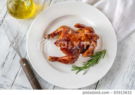 Roasted chicken on the white plate Roasted chicken on the white plate 83913632