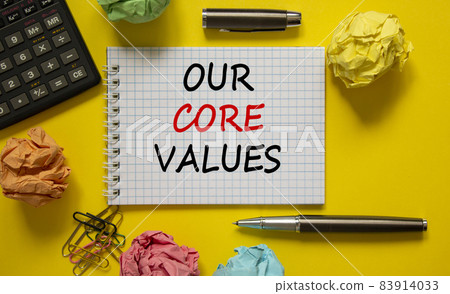 Our core values symbol. White note with words 'Our core values' on beautiful yellow table, colored paper, colored pencils, paper clips, coins and calculator. Business and our core values concept. Our core values symbol. White note with words 'Our core values' on beautiful yellow table, colored paper, colored pencils, paper clips, coins and calculator. Business and our core values concept. 83914033