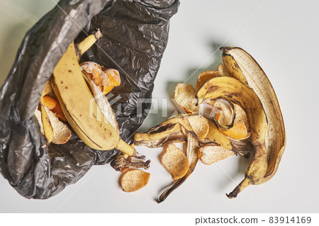 Banana peels in trash can. Using banana peels in compost. Banana skin in recycling bio bin in the kitchen 83914169