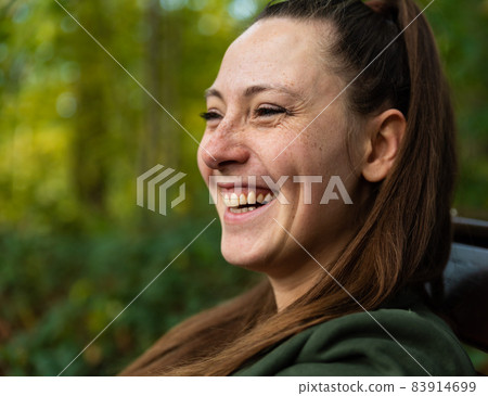 Portrait of a thirty year old attractive white woman outdoors, smiling 83914699