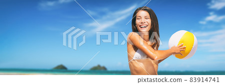 Vacation banner Asian woman playing with beach ball having fun happy background. Young mixed race bikini girl playing on summer holidays - smiling, enjoying the sun Hawaii. 83914741