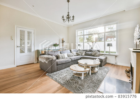 Living room with large comfortable gray sofa 83915776