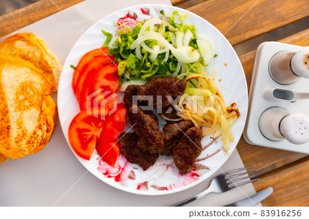 Traditional Turkish kofte prepared on mangal with vegetables 83916256