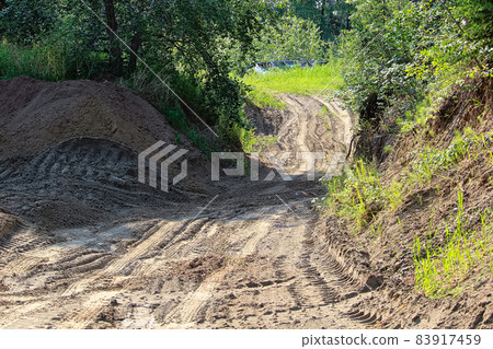 A sandy quadding trail with lots of tire tracks 83917459