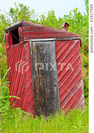 Closeup of a red toilet on a hiking trail 83917509