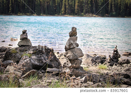 Cairn stacks built along a lake shore in summer Cairn stacks built along a lake shore in summer 83917601