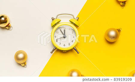 Christmas flat lay 2022. Retro style yellow clock in happy xmas midnight. Countdown to new year on happy xmas yellow background. Merry Christmas and Happy New Year. Christmas flat lay 2022. Retro style yellow clock in happy xmas midnight. Countdown to new year on happy xmas yellow background. Merry Christmas and Happy New Year. 83919109