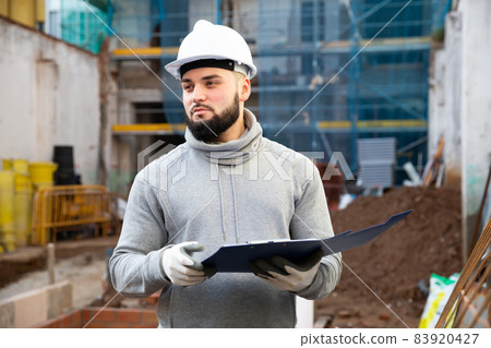 Engineer planning renovation works at building site Engineer planning renovation works at building site 83920427