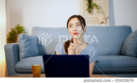 A young woman using a laptop A young woman using a laptop 83920674