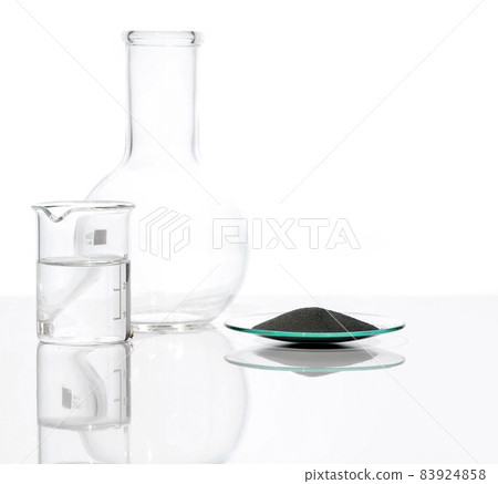 Zinc Powder in Chemical Watch Glass place next to crystal clear liquid in Beaker and Flat Bottom Flask (Borosilicate Glass). Close up chemical ingredient on white laboratory table. Side View Zinc Powder in Chemical Watch Glass place next to crystal clear liquid in Beaker and Flat Bottom Flask (Borosilicate Glass). Close up chemical ingredient on white laboratory table. Side View 83924858