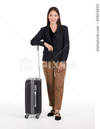 Young asian women in black suit smile and rest her arm on a black suitcase. Portrait on white background with studio light. Young asian women in black suit smile and rest her arm on a black suitcase. Portrait on white background with studio light. 83924859