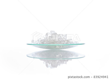 Closeup chemical ingredient on white laboratory table. Sodium Thiosulfate in Chemical Watch Glass. Side View Closeup chemical ingredient on white laboratory table. Sodium Thiosulfate in Chemical Watch Glass. Side View 83924941