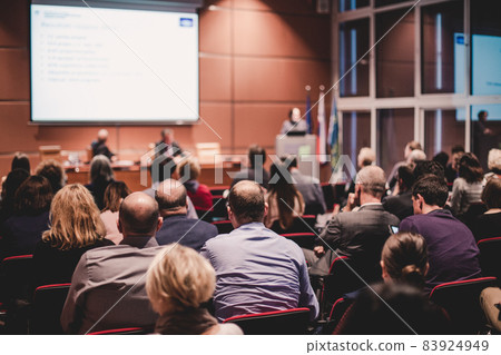 Audience in lecture hall participating at business event. Audience in lecture hall participating at business event. 83924949