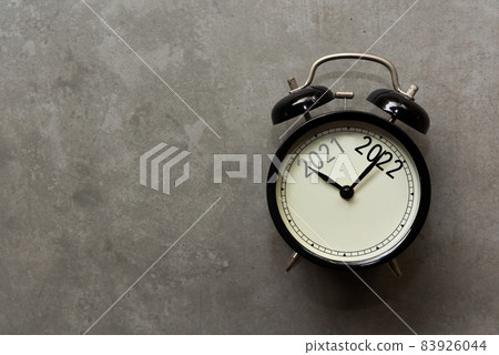 2021 and 2022 on black alarm clock on concrete with copy space , 83926044