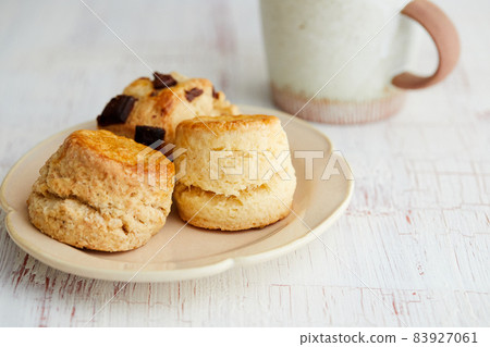 Various types of scones and mugs 83927061