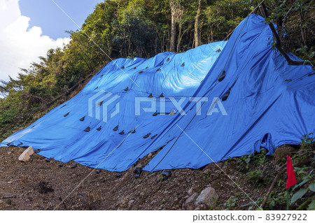 Collapse site covered with blue sheet Collapse site covered with blue sheet 83927922