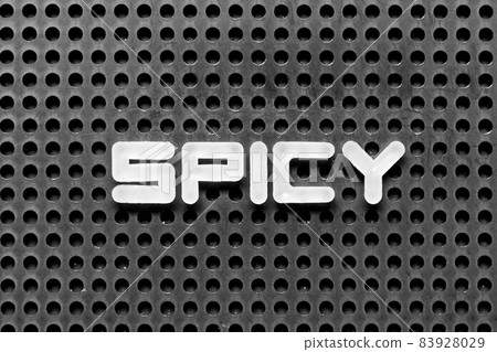 White alphabet letter in word spicy on black pegboard background White alphabet letter in word spicy on black pegboard background 83928029