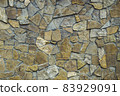 Wall of stone lined with brown limestone. 83929091