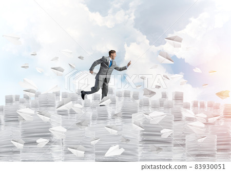 Precise businessman in suit running with phone. 83930051