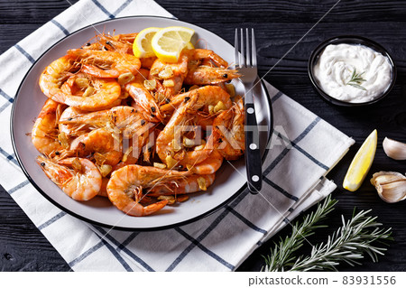 Grilled garlic butter prawns on a plate Grilled garlic butter prawns on a plate 83931556