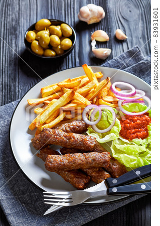cevapcici with potato fries, lettuce, onion, ajvar 83931601