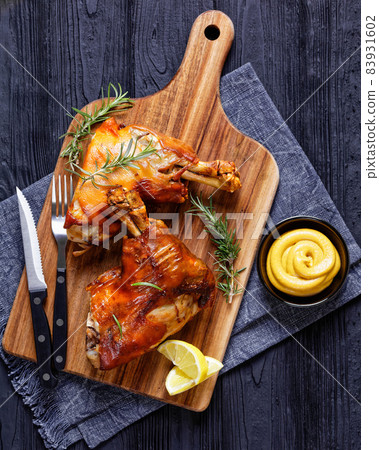 roasted pork shanks on a wood board, top view 83931602