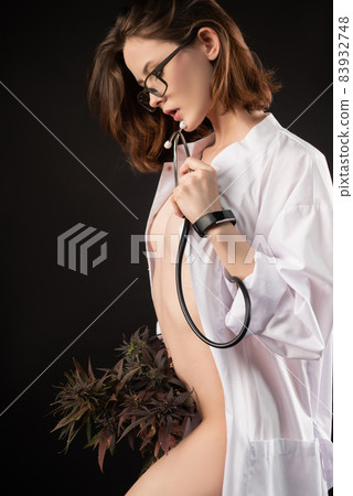 naked girl in a medical gown with a bouquet of marijuana naked girl in a medical gown with a bouquet of marijuana 83932748
