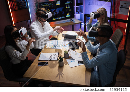 Diverse company workers using VR headset during conference 83934115