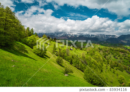 Spring landscape with snowy mountains and spectacular hills, Transylvania, Romania 83934116