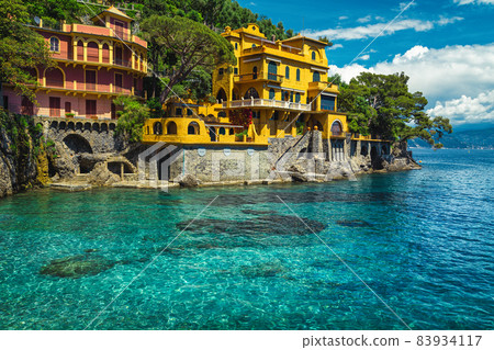 Colorful waterfront houses with beautiful azure blue beach, Portofino, Italy 83934117