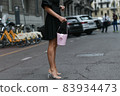 Milan, Italy - September 25, 2021:  Street style outfit, woman wearing a fashionable outfit on the streets of Milan, Italy. 83934473