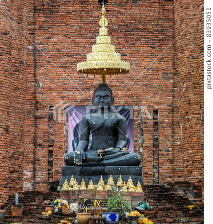 Ancient Buddha statue and the wall made by old red brick background at Wat Thammikarat. 83935051