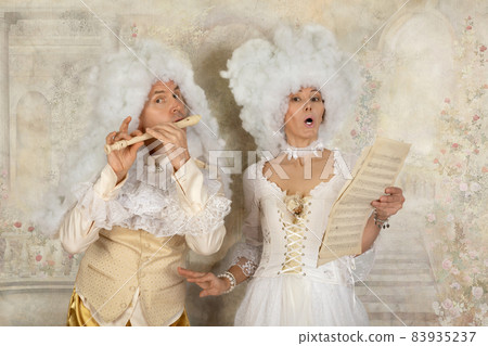 Fun couple in white wigs and Baroque style clothes Fun couple in white wigs and Baroque style clothes 83935237
